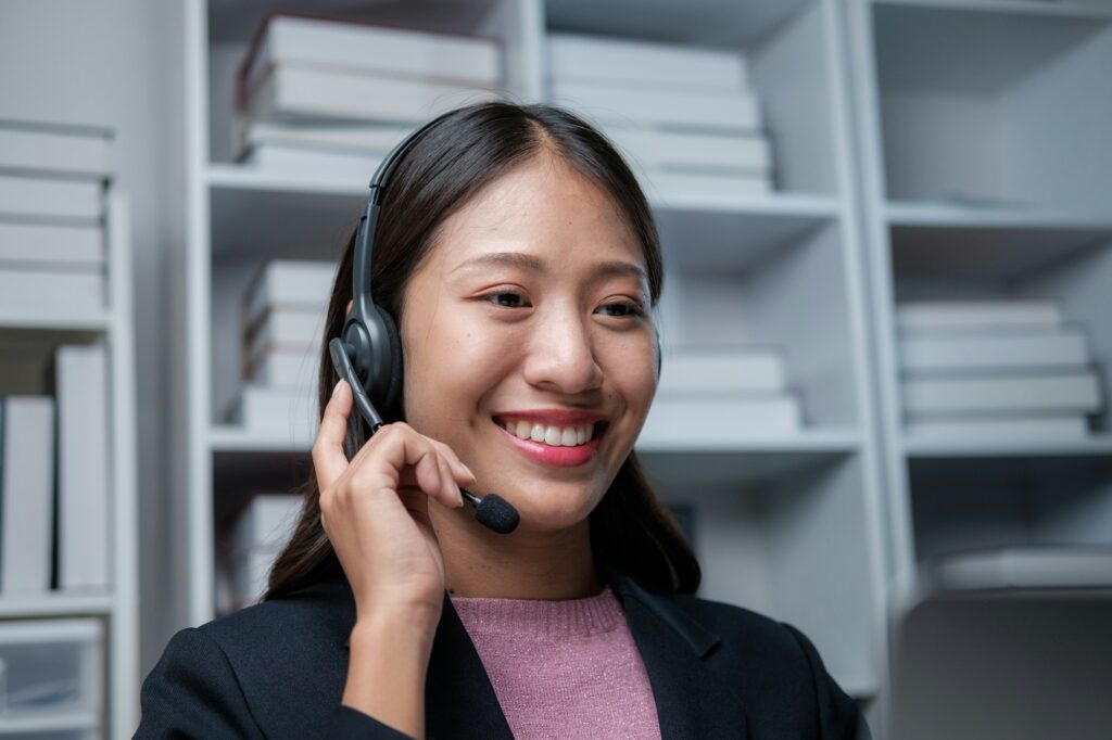 Businesswoman in wireless headset call center agent telemarketer consulting client participating.