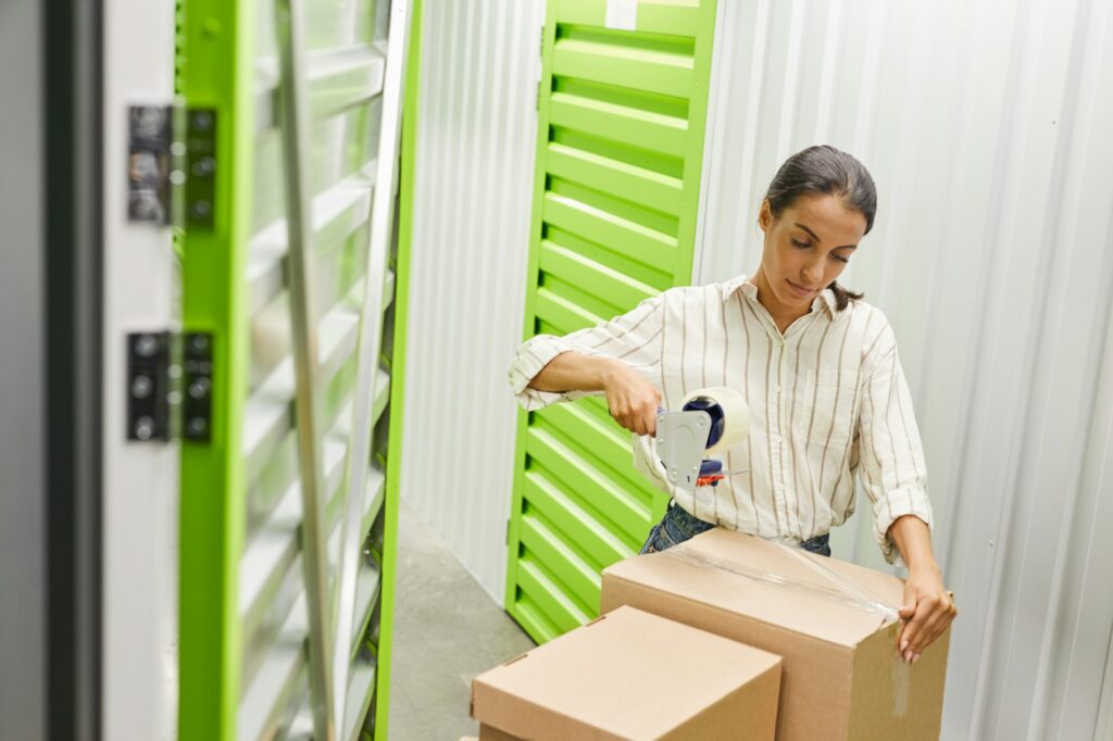 Woman Packing Boxes in Storage Facility